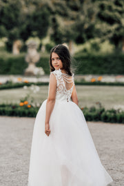 Enchanting princess dress in white with a voluminous, long tulle skirt,satin top with intricate lace embroidery, open back and pearl details.
