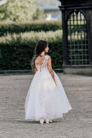 Enchanting princess dress in white with a voluminous, long tulle skirt,satin top with intricate lace embroidery, open back and pearl details.