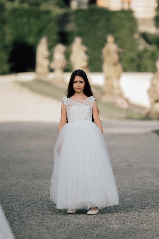 Enchanting princess dress in white with a voluminous, long tulle skirt,satin top with intricate lace embroidery, open back and pearl details.