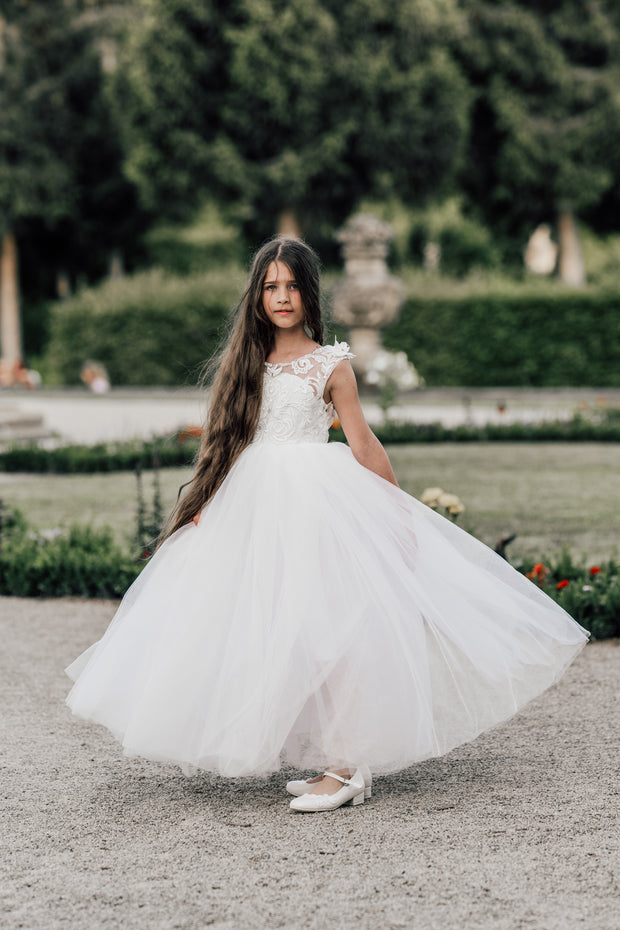 Enchanting princess dress in white with a voluminous, long tulle skirt,satin top with intricate lace embroidery, open back and pearl details.