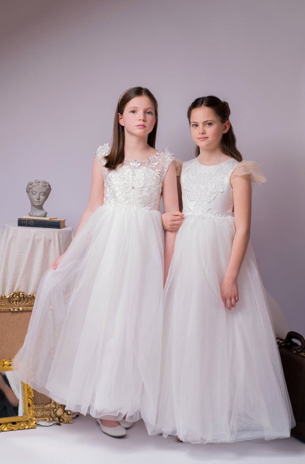 Long flower girl dress in white with a long, tulle train, lace embroidery, open back with lace and a big bow. For special occasions: Wedding, Birthday party, Prom, Flower girl, Eid, and other events.