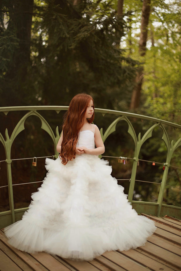 Enchanting fairy tale princess look with a long, white ball gown with voluminous skirt with tulle ruffles and open back. Occasions: Wedding, Birthday party, Prom, Flower girl, Eid, and other events.