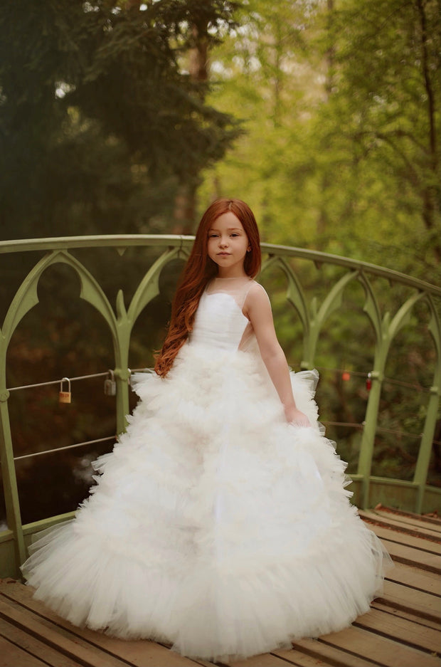 Enchanting fairy tale princess look with a long, white ball gown with voluminous skirt with tulle ruffles and open back. Occasions: Wedding, Birthday party, Prom, Flower girl, Eid, and other events.