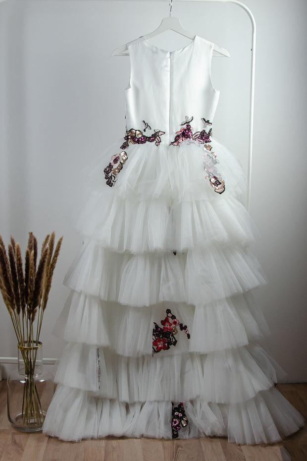 handmade long white flower girl dress with a multi-layered tulle skirt and pink and red floral embroidery