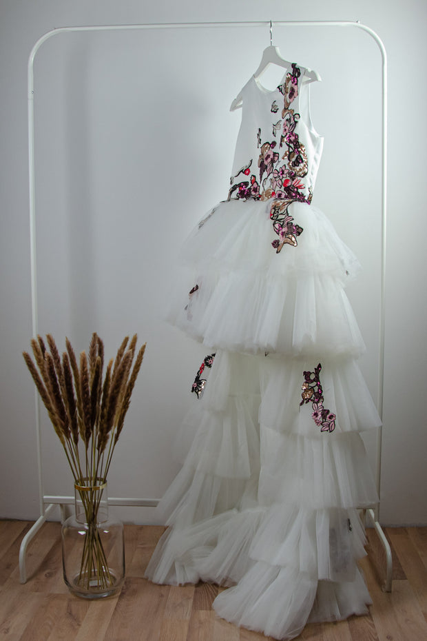 handmade long white flower girl dress with a multi-layered tulle skirt and pink and red floral embroidery