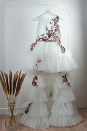 handmade long white flower girl dress with a multi-layered tulle skirt and pink and red floral embroidery
