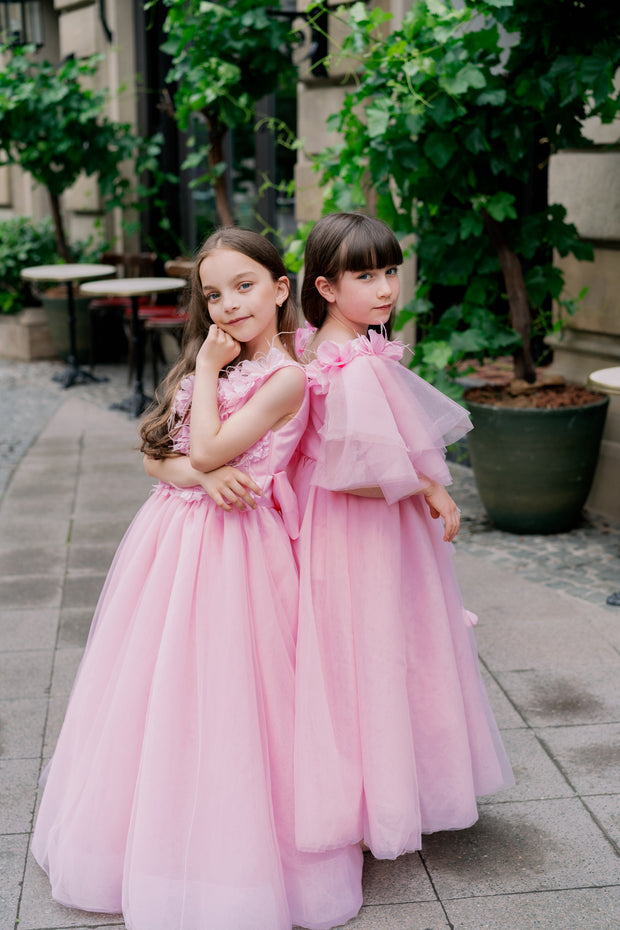 Long pink princess girl dress with a long tulle skirt, asymmetrical sleeves and all-over 3D flower embellishments. For special occasions: flower girls, weddings, Eid, princess birthday party.