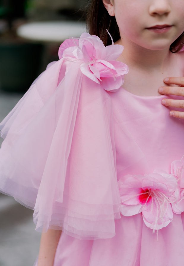 Long pink princess girl dress with a long tulle skirt, asymmetrical sleeves and all-over 3D flower embellishments. For special occasions: flower girls, weddings, Eid, princess birthday party.