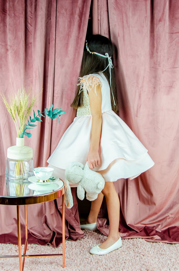 Midi satin girl dress in light apricot colour with a multi-layered satin skirt, short sleeves with feather details and satin top embellished with pearls.