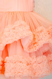 Knee-length multi-layered tulle princess girl dress in a bright salmon colour perfect your spring and summer special occasions: flower girls, weddings, birthday.