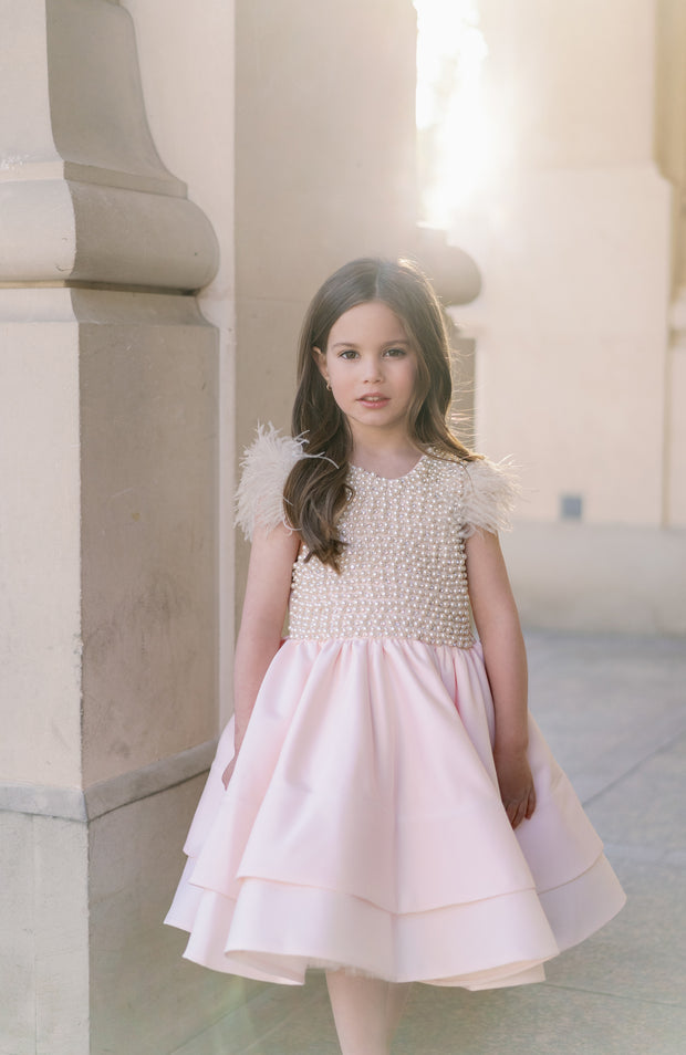 Midi satin girl dress in light apricot colour with a multi-layered satin skirt, short sleeves with feather details and satin top embellished with pearls.