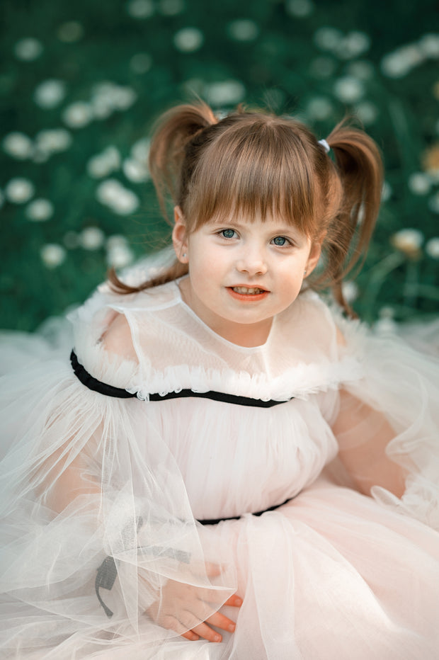 Short baby girl dress in light pink with long tulle sleeves and contrasting black ribbon details for special occasions: Wedding, Birthday party, Prom, Flower girl, Eid, and other events.