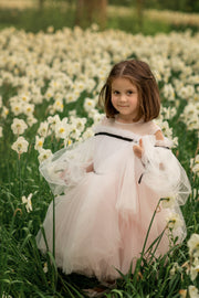 Short baby girl dress in light pink with long tulle sleeves and contrasting black ribbon details for special occasions: Wedding, Birthday party, Prom, Flower girl, Eid, and other events.