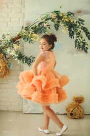 Knee-length multi-layered tulle princess girl dress in a bright salmon colour perfect your spring and summer special occasions: flower girls, weddings, birthday.