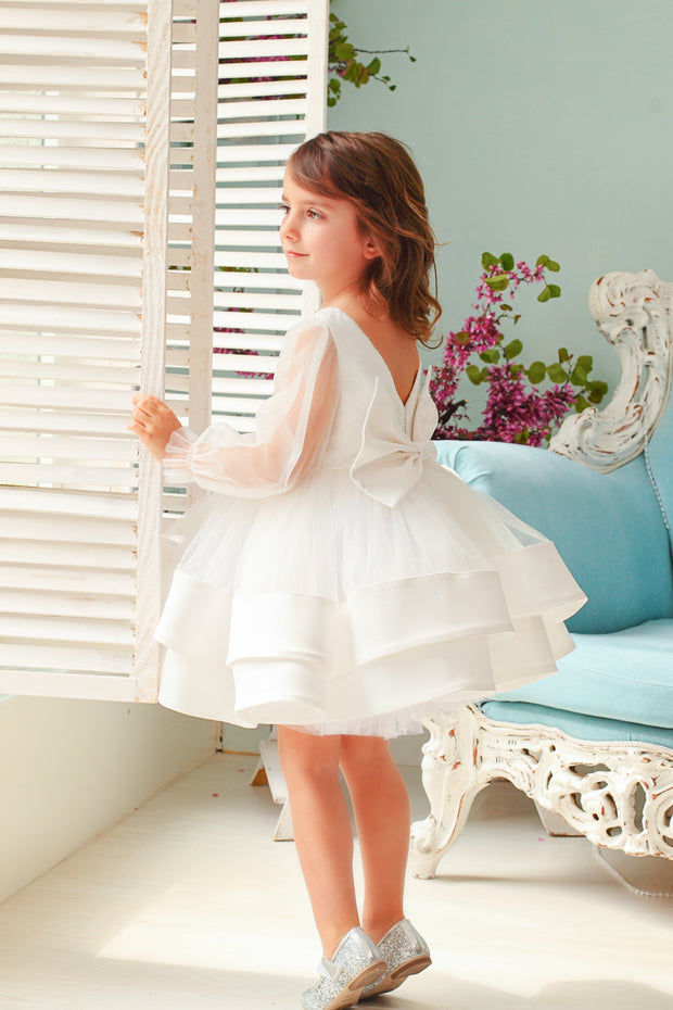 Handmade short white flower girl's dress with a multi-layered tutu skirt, golden embroidery and a big bow on the back