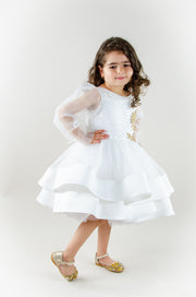 Handmade short white flower girl's dress with a multi-layered tutu skirt, golden embroidery and a big bow on the back