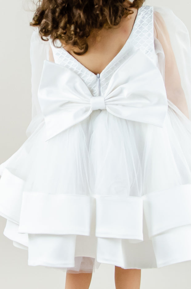 Handmade short white flower girl's dress with a multi-layered tutu skirt, golden embroidery and a big bow on the back