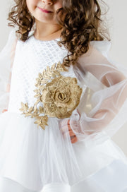 Handmade short white flower girl's dress with a multi-layered tutu skirt, golden embroidery and a big bow on the back