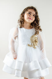 Handmade short white flower girl's dress with a multi-layered tutu skirt, golden embroidery and a big bow on the back