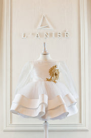 Handmade short white flower girl's dress with a multi-layered tutu skirt, golden embroidery and a big bow on the back