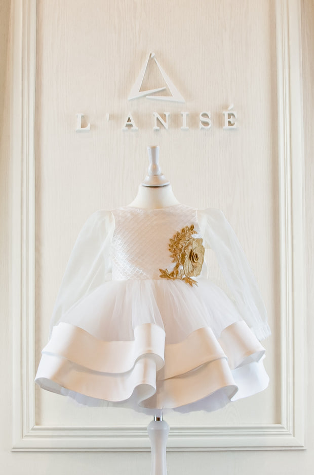 Handmade short white flower girl's dress with a multi-layered tutu skirt, golden embroidery and a big bow on the back