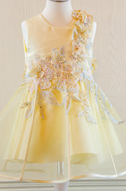 handmade short A-line yellow flower girl dress with a short tulle skirt and hand embroidered top with pastel flowers, pearls and rhinestones