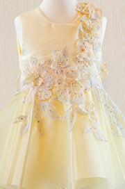 handmade short A-line yellow flower girl dress with a short tulle skirt and hand embroidered top with pastel flowers, pearls and rhinestones