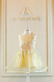 handmade short A-line yellow flower girl dress with a short tulle skirt and hand embroidered top with pastel flowers, pearls and rhinestones