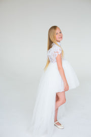 handmade, white princess girl dress with a high low hemline, short white tutu, tulle train, lace top, short sleeves and feather details.