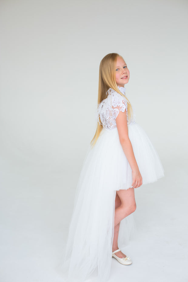handmade, white princess girl dress with a high low hemline, short white tutu, tulle train, lace top, short sleeves and feather details.