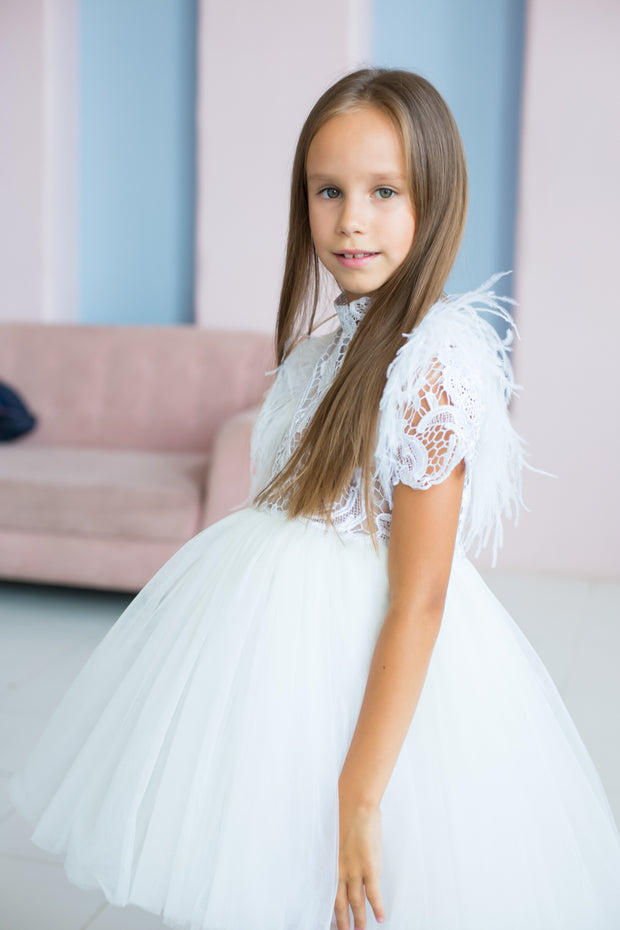 handmade, white princess girl dress with a high low hemline, short white tutu, tulle train, lace top, short sleeves and feather details.