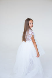 handmade, white princess girl dress with a high low hemline, short white tutu, tulle train, lace top, short sleeves and feather details.