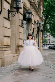 Long, white princess girl dress with a long, voluminous tulle skirt, embroidered top and big bows on the sleeves. For special occasions: flower girls, weddings, princess birthday party.