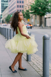 Knee-lenght bright yellow girl tutu dress with ruffles, asymmetrical pleated tulle top and a big 3D flower detail. For special occasions: Wedding, Birthday party, Prom, Flower girl, Eid, and other events.