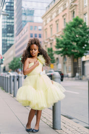 Knee-lenght bright yellow girl tutu dress with ruffles, asymmetrical pleated tulle top and a big 3D flower detail. For special occasions: Wedding, Birthday party, Prom, Flower girl, Eid, and other events.