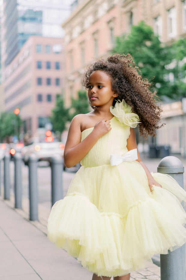 Knee-lenght bright yellow girl tutu dress with ruffles, asymmetrical pleated tulle top and a big 3D flower detail. For special occasions: Wedding, Birthday party, Prom, Flower girl, Eid, and other events.